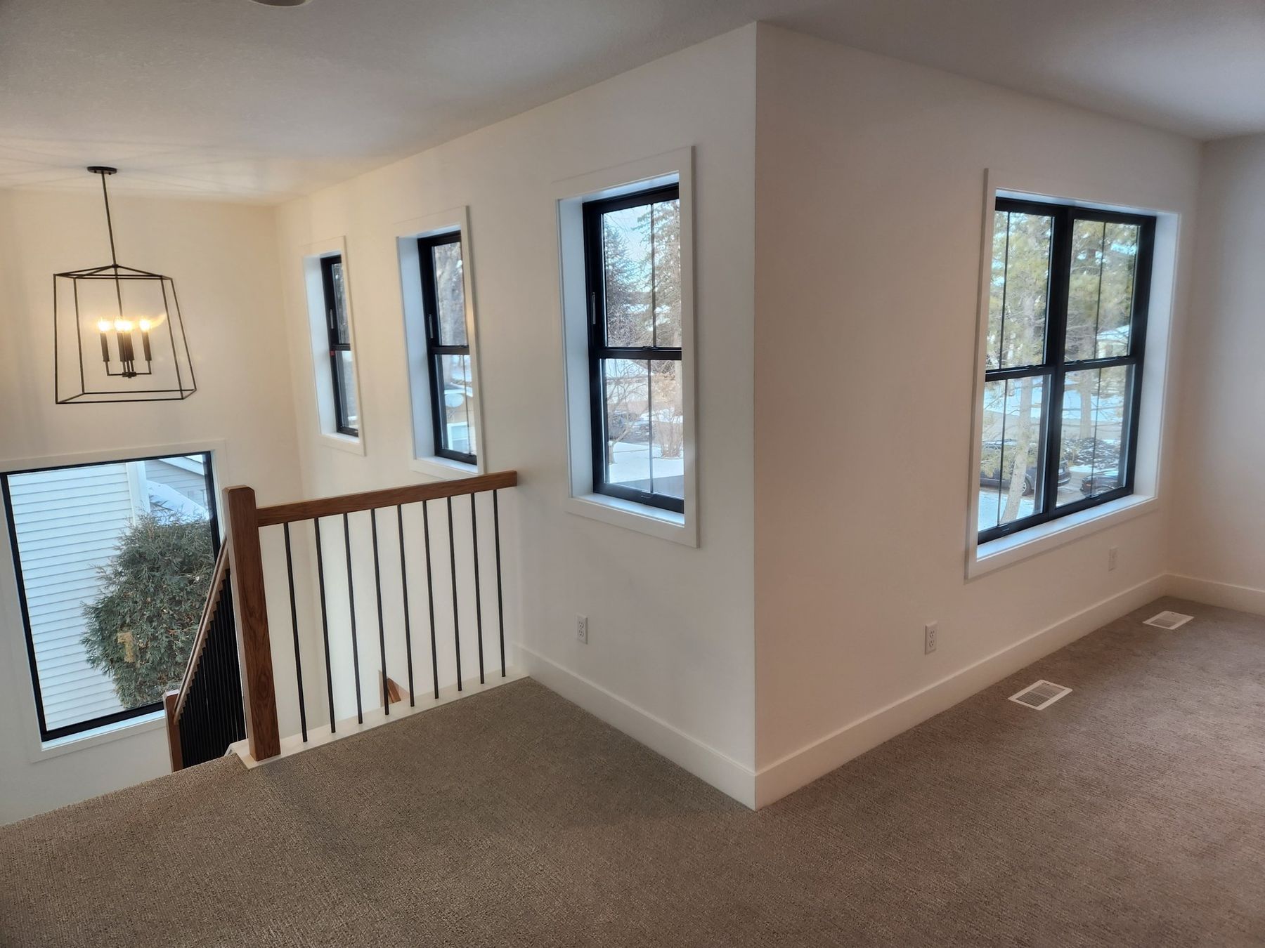 Upstairs landing with black windows and white trim