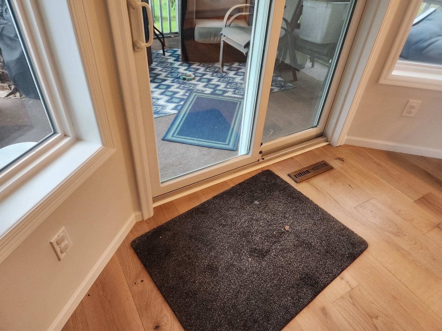 Patio door casing painted white next to new white-oak floors
