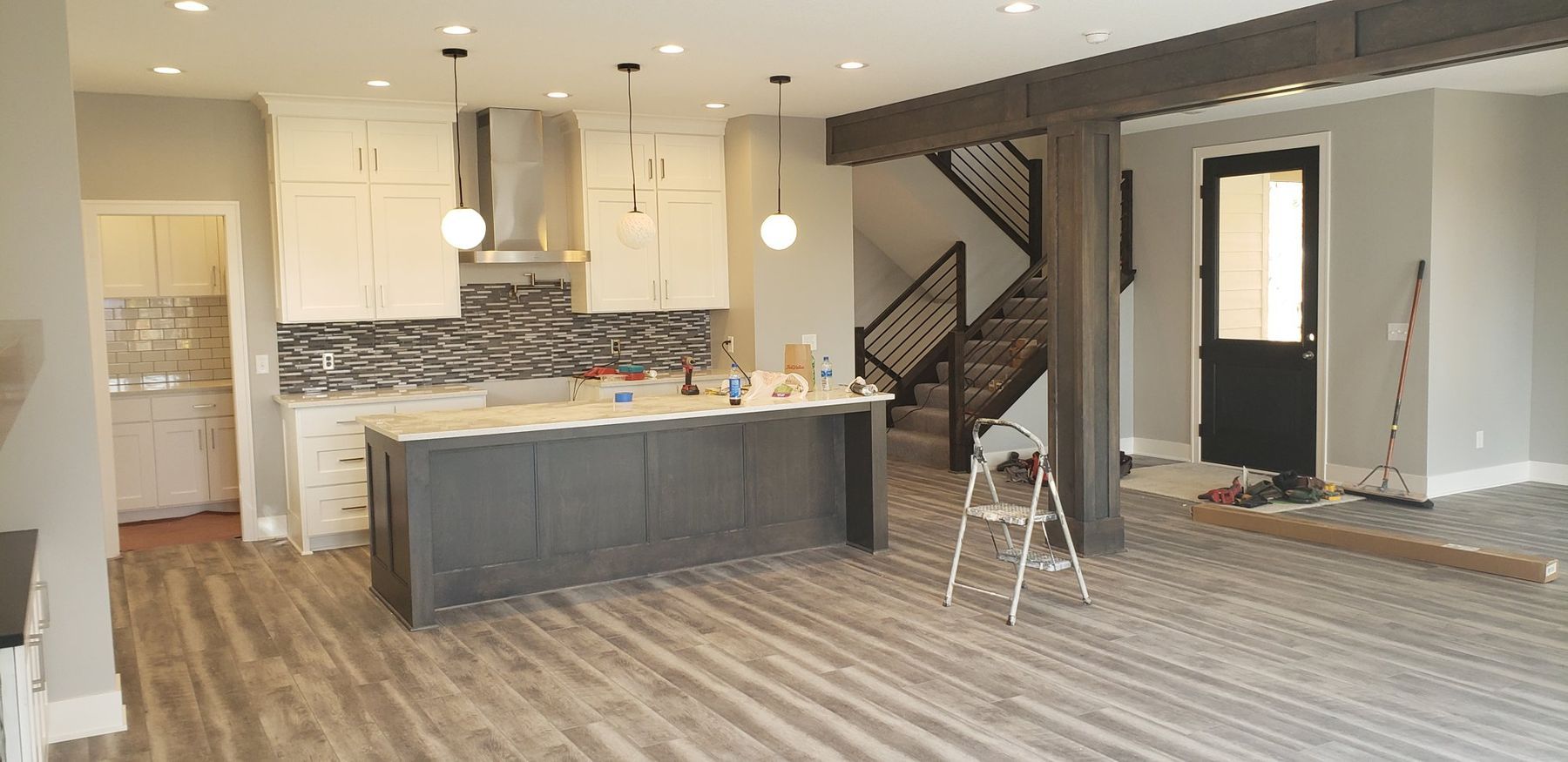 Kitchen with gray island and white walls