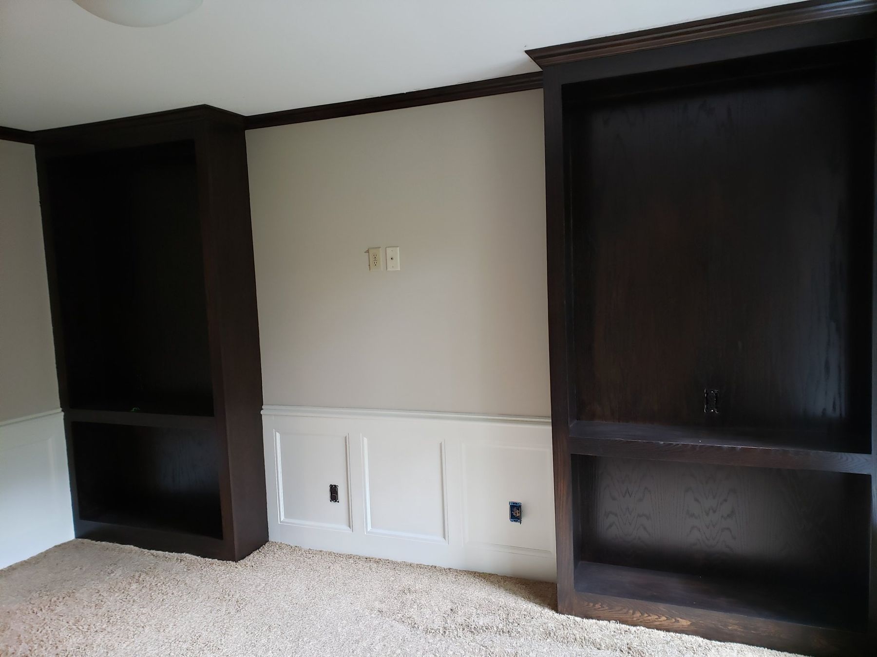 Den built-ins restained espresso above white wainscoting