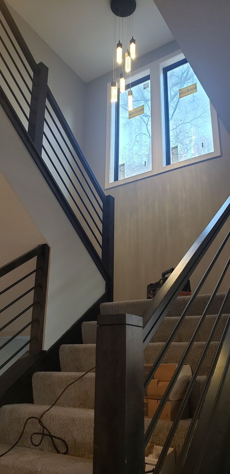 Two-story stairwell with black railing