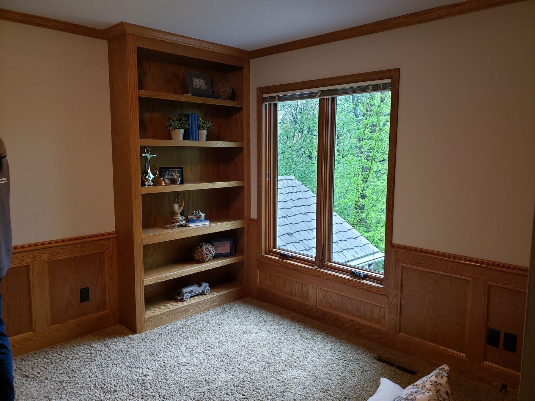Before: golden oak den built-ins and wainscoting