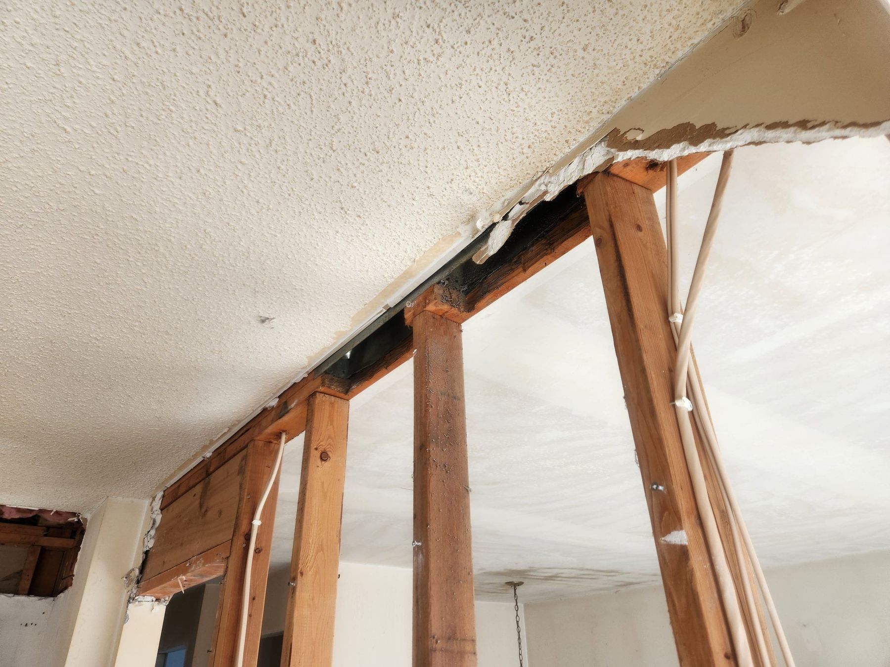 Before: popcorn ceiling above the kitchen soffit being opened up