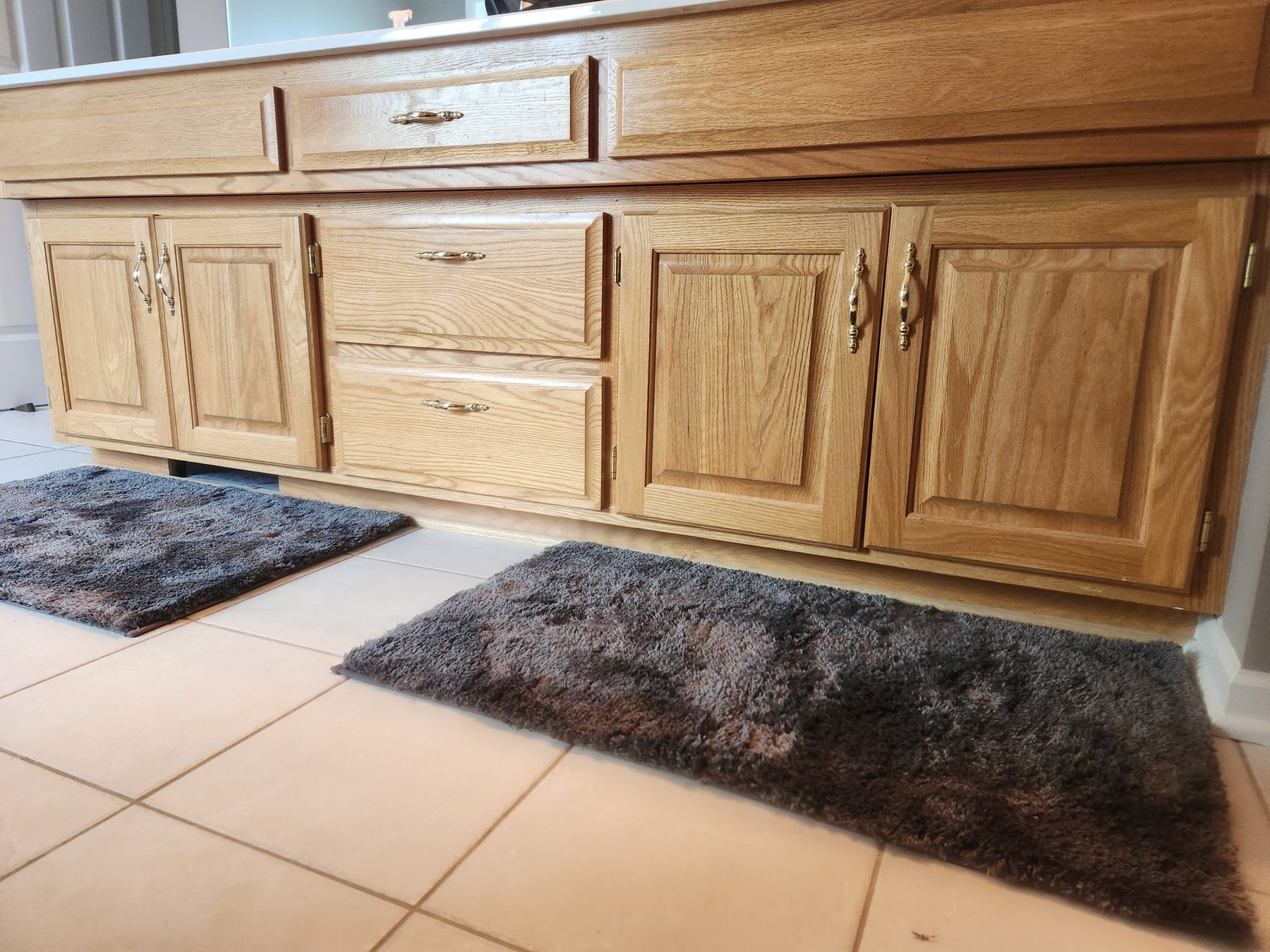 Before: golden oak vanity doors and drawers