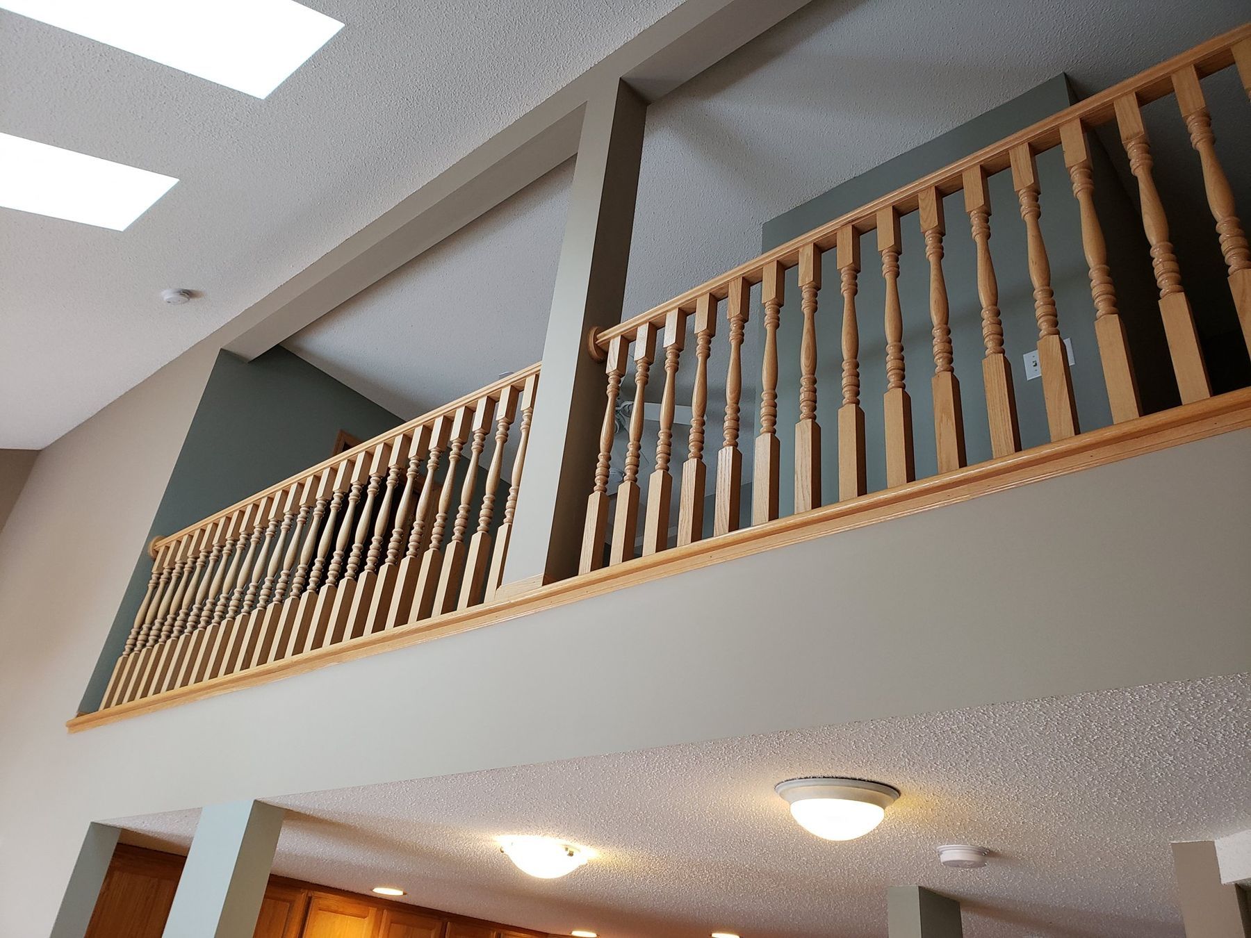 Before: golden oak loft railing and balusters