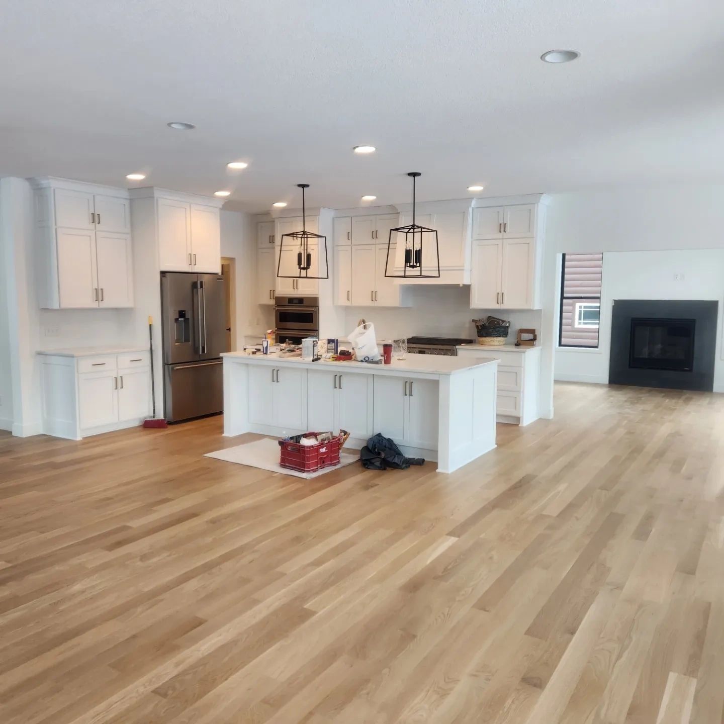 Open kitchen with white painted cabinets and island