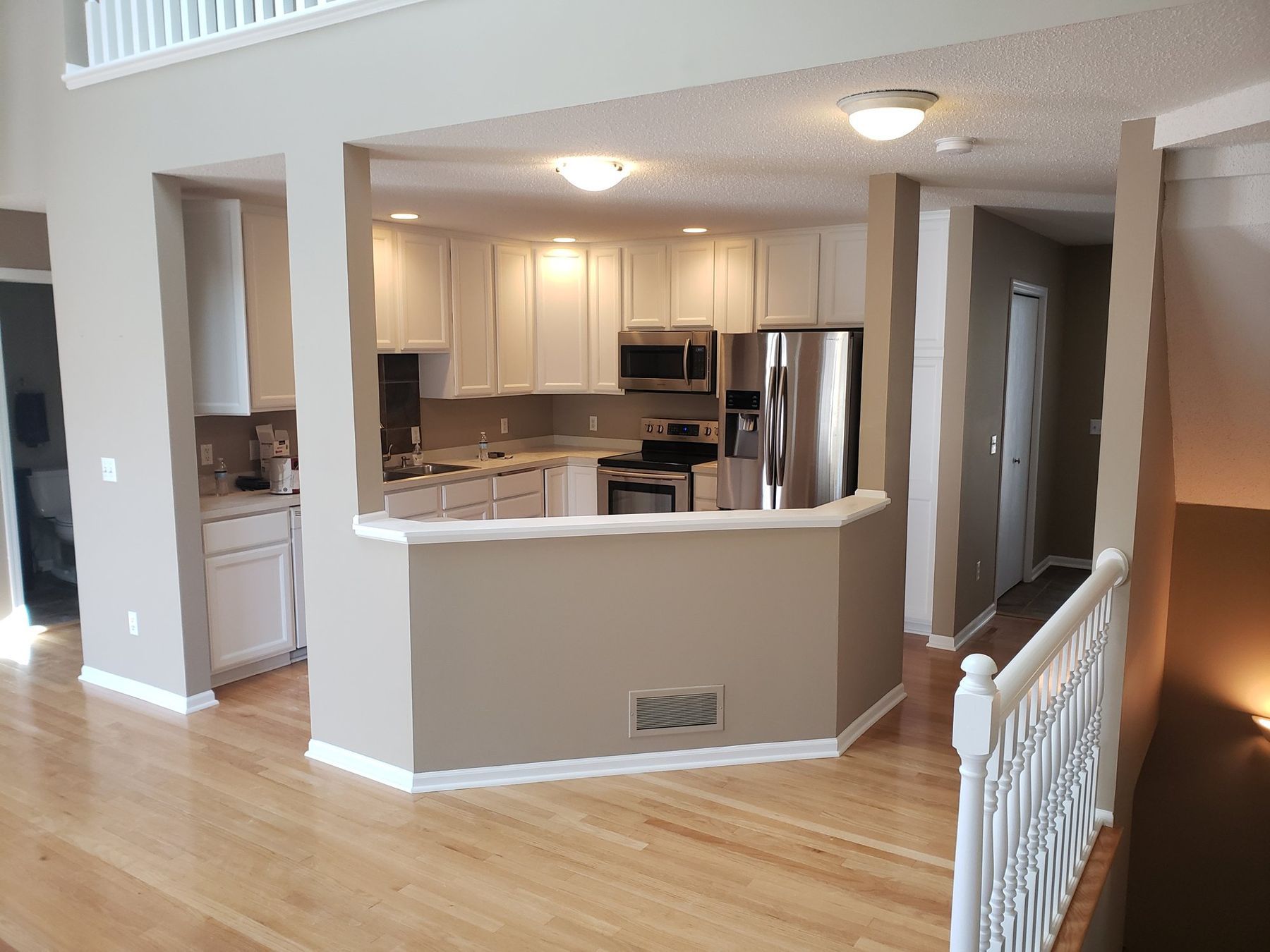 After: Kitchen: golden oak cabinets sprayed white