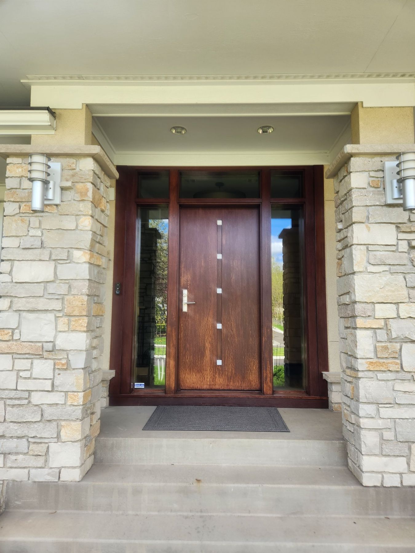 Before: Entry door: faded, weathered finish to a restained, clear-coated door