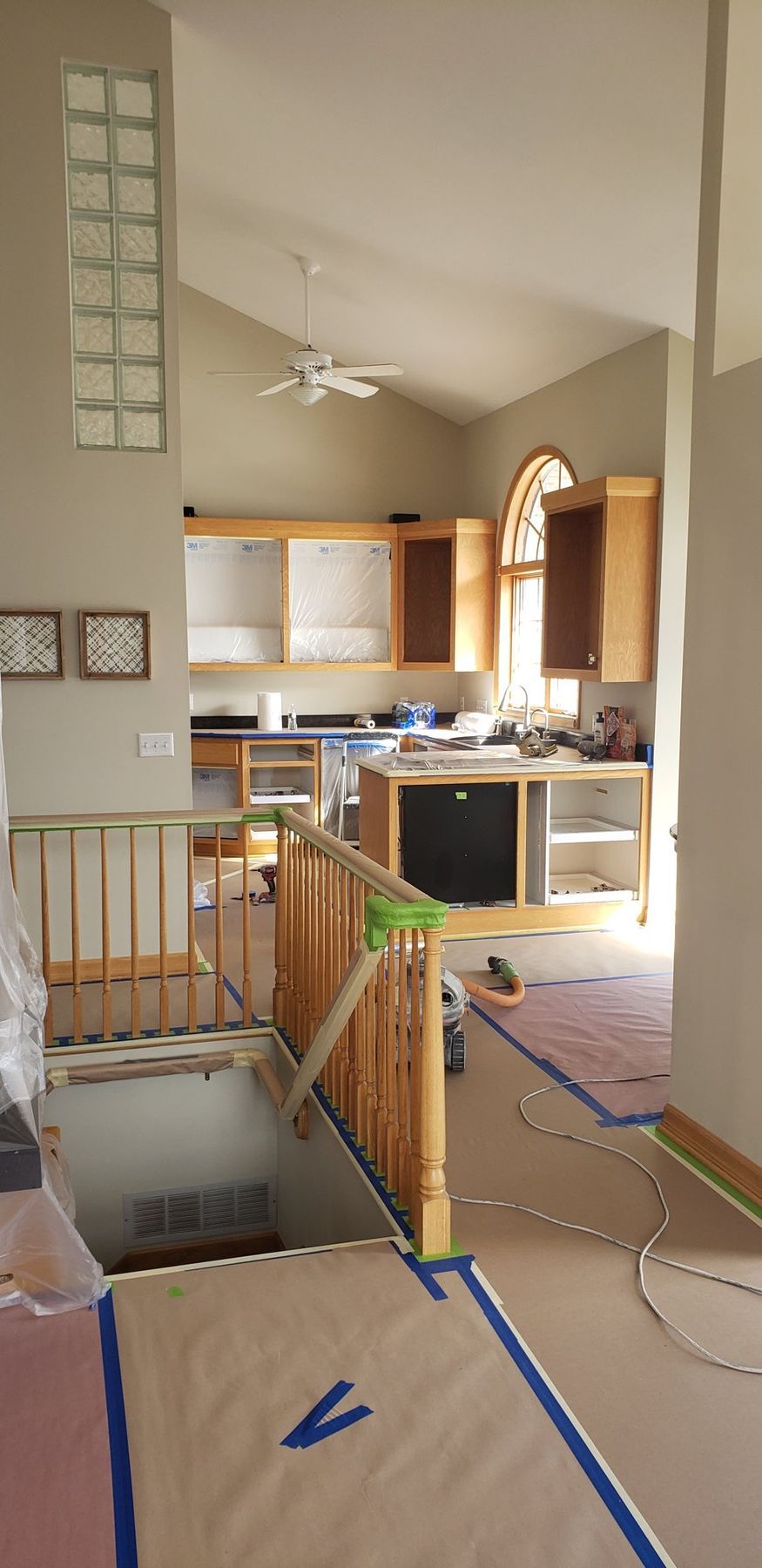Before: Kitchen and stair: golden oak cabinets, rail and trim painted white