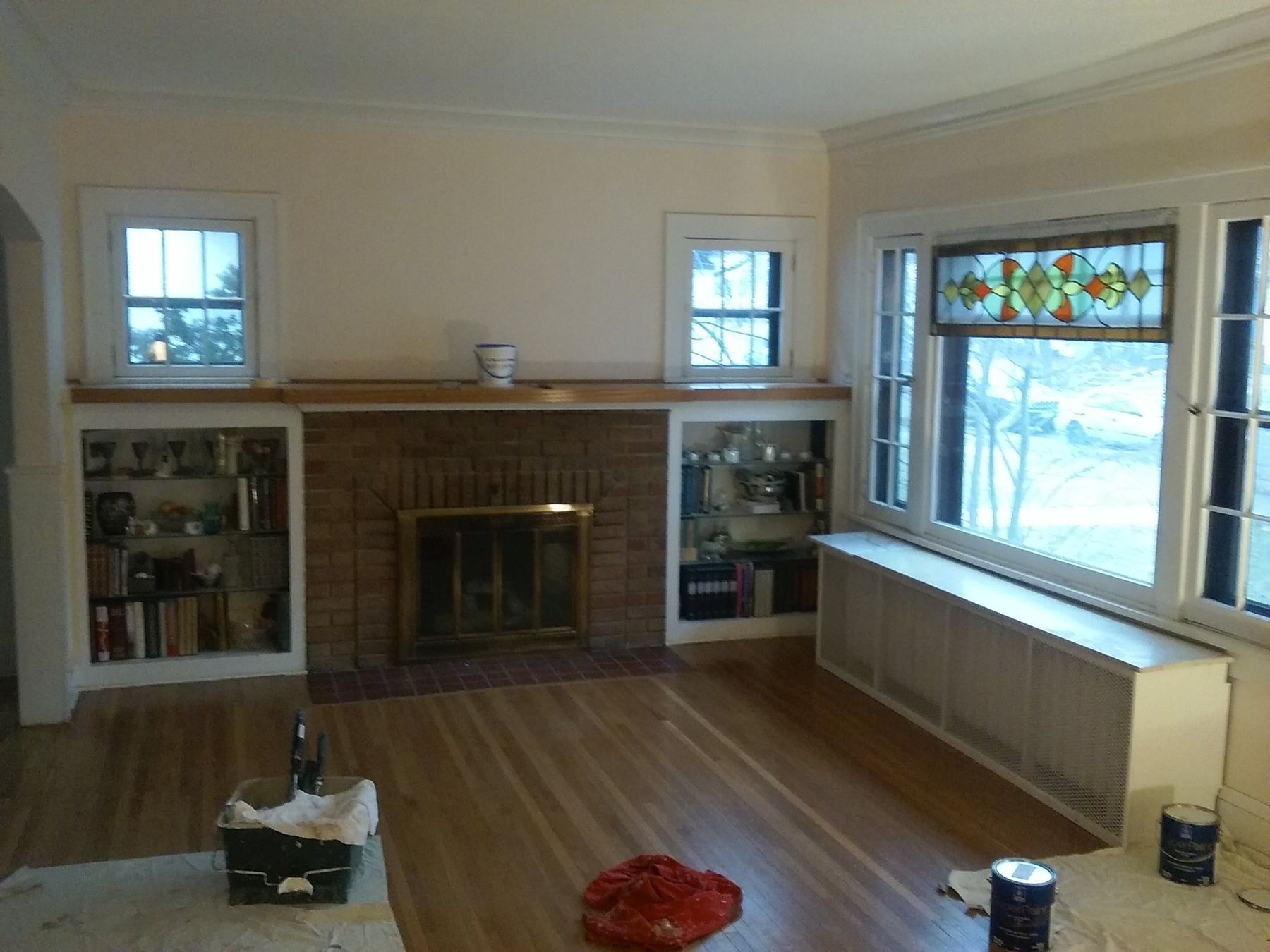 Before: Living room fireplace wall: cream walls to light gray with white trim