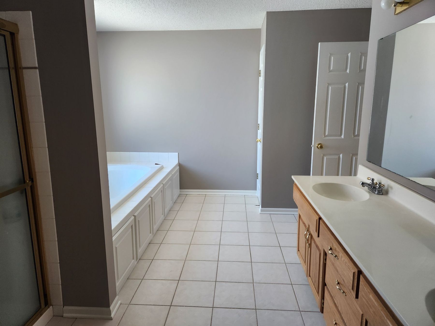 After: Primary bath: plum walls repainted light gray