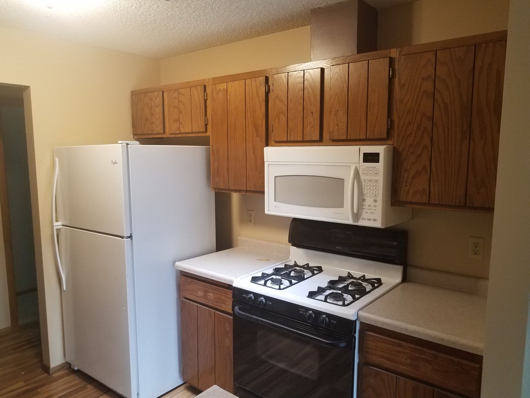 Before: Range wall: golden oak cabinets to off-white