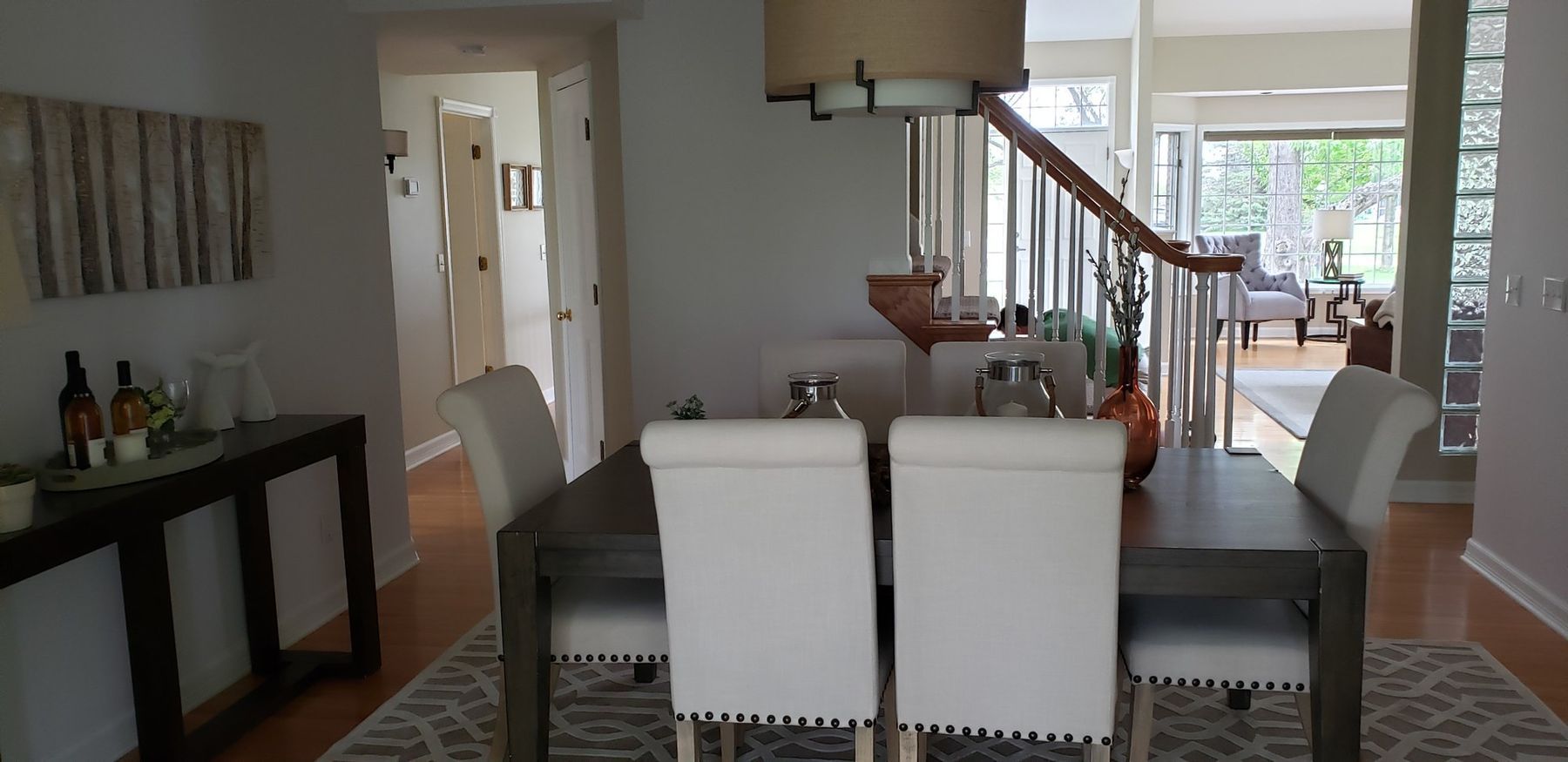 After: Dining room: oak trim and doors painted white, walls lightened
