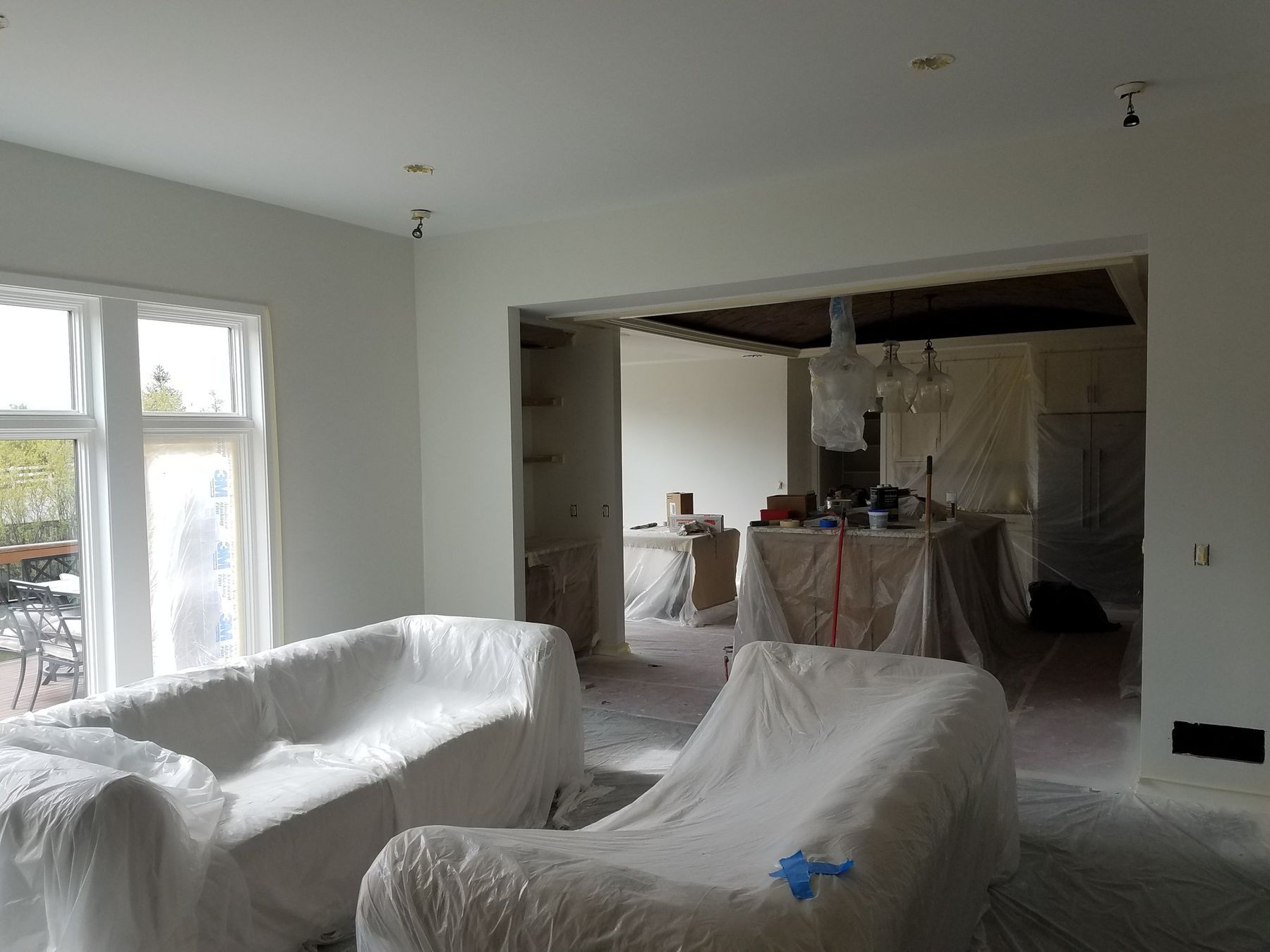 Furniture wrapped in plastic, walls skimmed and primed