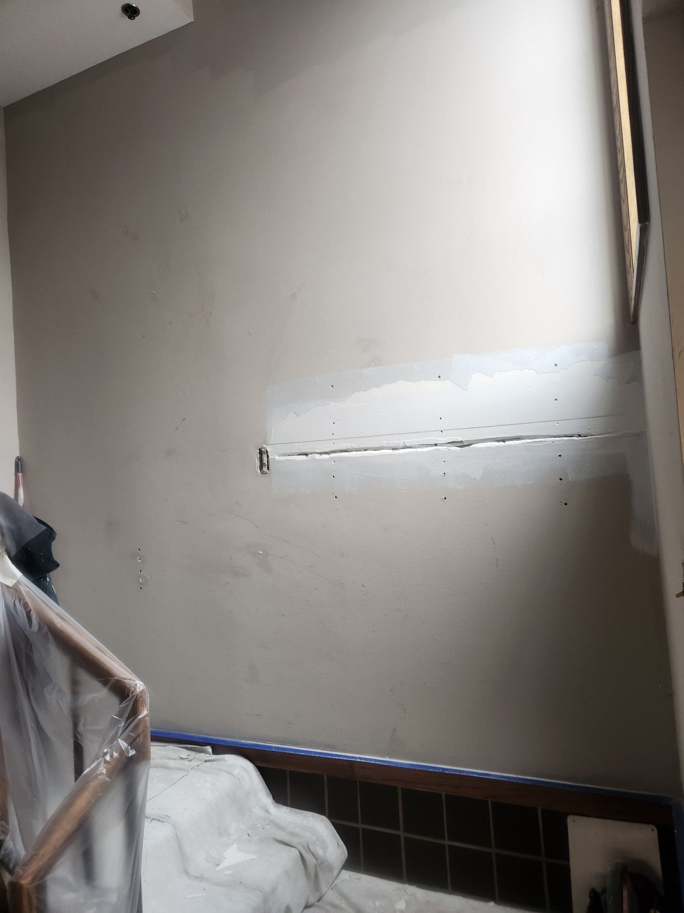Stairwell wall patched and primed