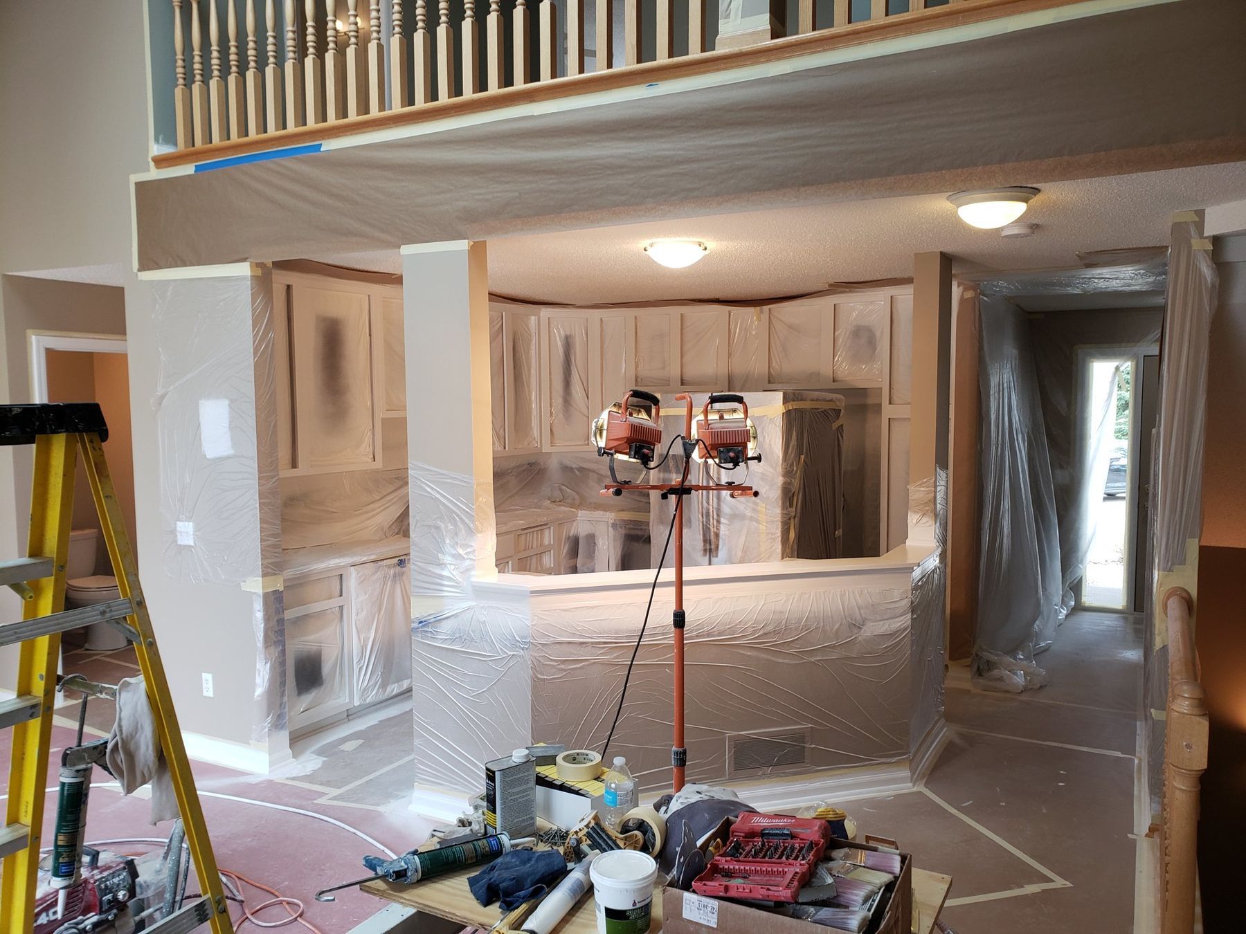Kitchen sealed in plastic with work lights for spraying