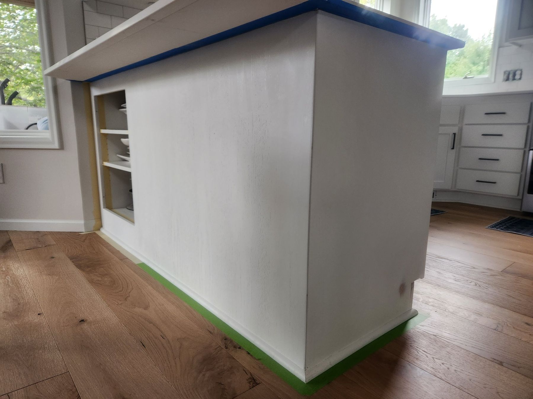 Kitchen island primed with floors masked